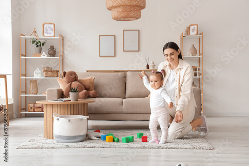 Mother playing with her bab...
