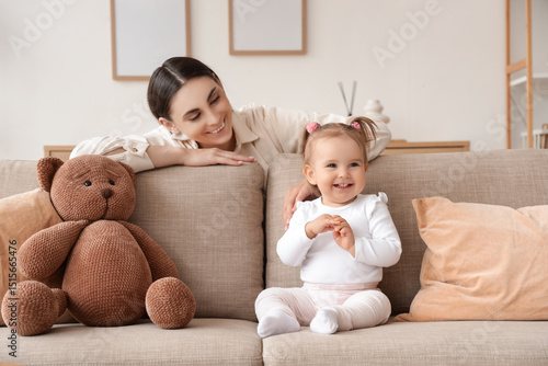 Mother with her baby on sof...
