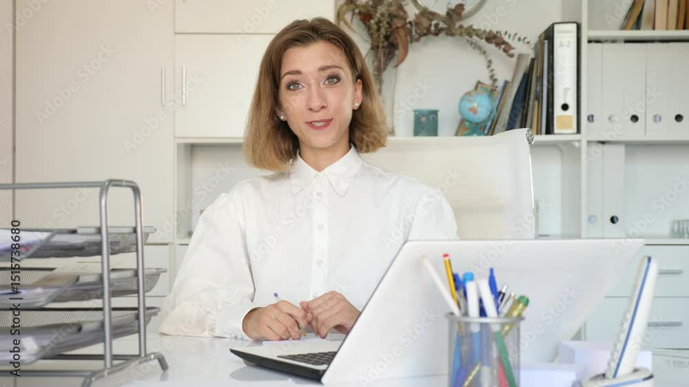 Successful young business woman using laptop at workplace Successful young business woman using laptop at workplace