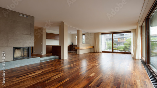 Modern living room with wooden floors and neutral walls  showcasing minimalist design and open space.