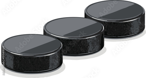 black hockey pucks in a close-up shot
