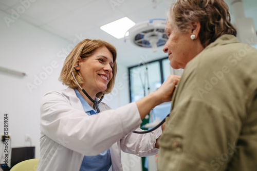 Fotografija Geriatrician doctor examining elderly patient with stethoscope.