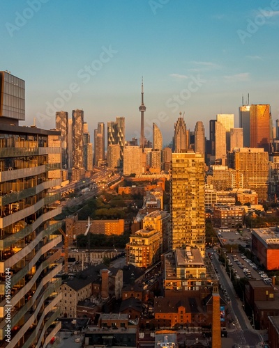 Toronto skyline at sunset with CN Tower and skyscrapers.