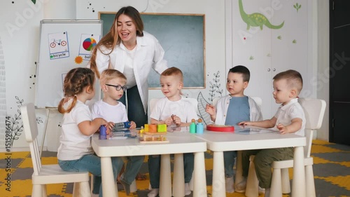 Objects, naming of them, education. Children in kindergarten with their teacher.
