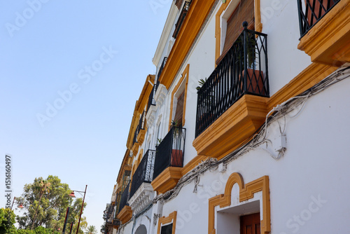 Historic Seville architecture with ornate facades, colourful exteriors, and traditional balconies reflecting Andalusian charm under the Spanish sun.