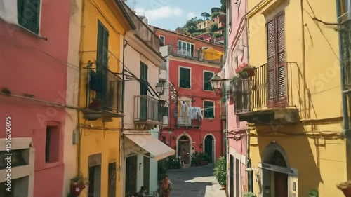 Colorful narrow street in a coastal village with laundry hanging, vibrant buildings, and sunny sky