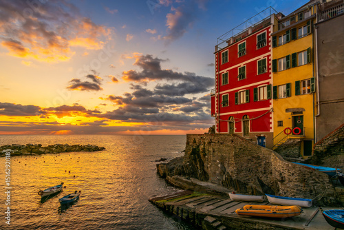 Scenic view of the village of Riomaggiore in Cinque Terre in Italy against dramatic sky at sunset
