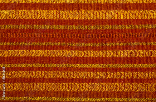 A striped wool fabric material closeup in red orange and yellow