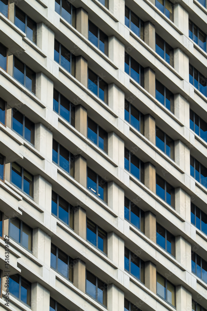 Modern Office Building Facade with Repetitive Window Pattern and Concrete Grid Architecture Modern Office Building Facade with Repetitive Window Pattern and Concrete Grid Architecture