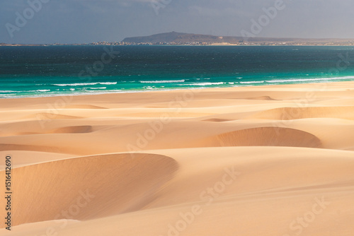 Sweeping sand dunes meet the turquoise waters of the Atlantic Ocean on Boa Vista Island, Cape Verde – a stunning fusion of desert and sea in a tropical paradise