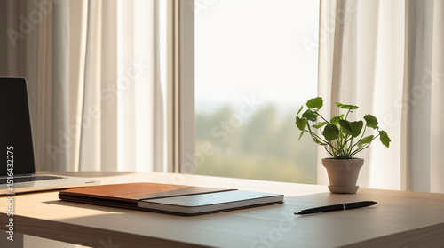 Minimalist Home Office Setup - A clean, organized desk with a laptop, notebook, and potted plant, bathed in natural light from a window.