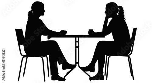 Two women having a conversation at a cafe table.