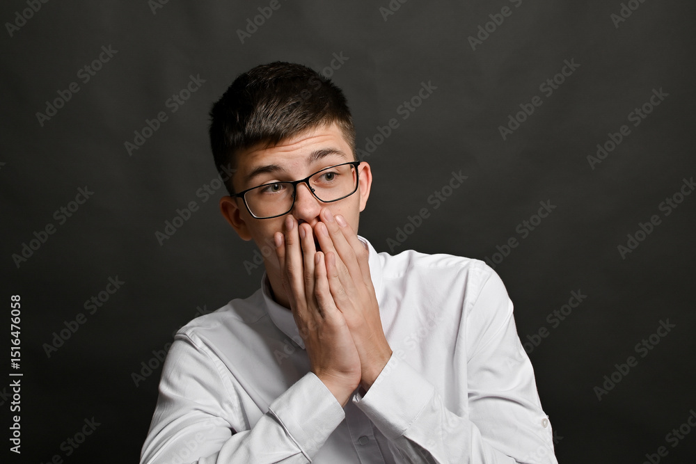 Body language tells story of personal stress or shocking discovery. hands are raised to mouth. Facial expression and hand gesture emphasize tension. pose evokes real-time surprise or internal panic. Body language tells story of personal stress or shocking discovery. hands are raised to mouth. Facial expression and hand gesture emphasize tension. pose evokes real-time surprise or internal panic.