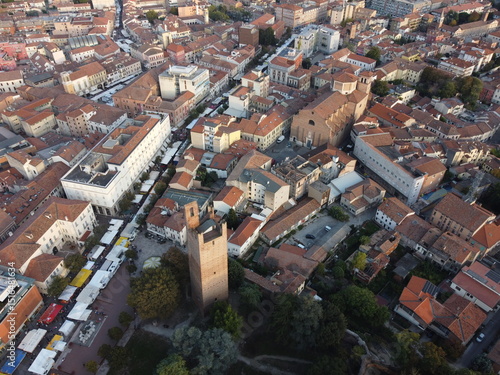 Aerial drone view of Rovigo city center, Veneto, showcasing the medieval Donà Tower, ancient castle ruins, and a mix of historic and modern buildings.