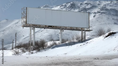 Blank billboard stands stark against snowy mountains, offering advertising space for creative campaigns in winter landscapes.