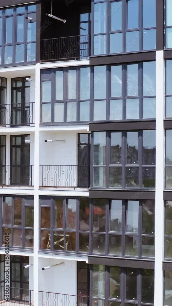 Drone view of apartment buildings. Aerial view of the facade of new residential complex in minimalist style Drone view of apartment buildings. Aerial view of the facade of new residential complex in minimalist style