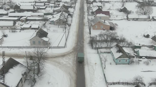 Aerial Drone Shot of Old Truck Driving Through Snowy Rural Landscape