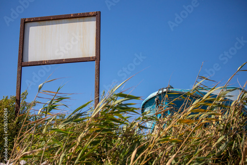 A rusty sign with a copy of the space