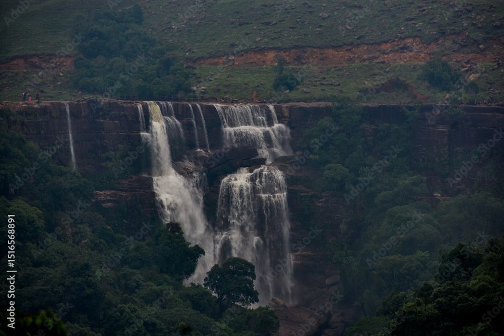 Fototapeta premium Dainthlen waterfall of Meghalaya, a Majestic multi-tiered waterfall cascading through dense forest, captured in serene wilderness.