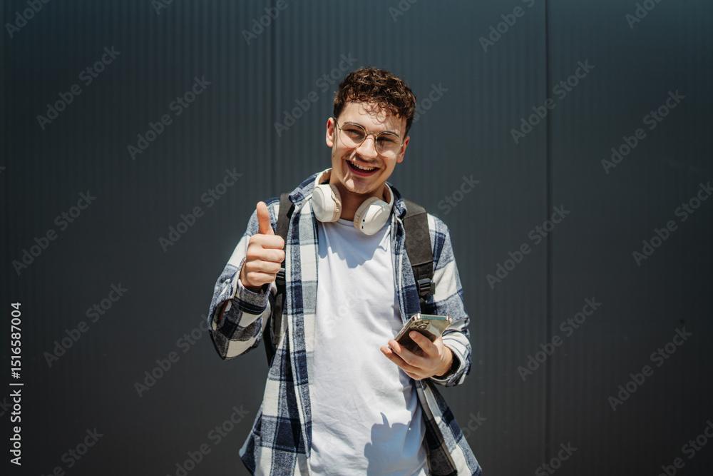 Portrait of a young adult man student smile using smartphone
Portrait of a young adult man student smile using smartphone