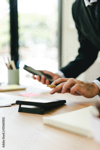 Portrait working on smartphone and calculating tax in modern office. Preparing accounting analysis report, real estate investment information, financial and tax system concept.