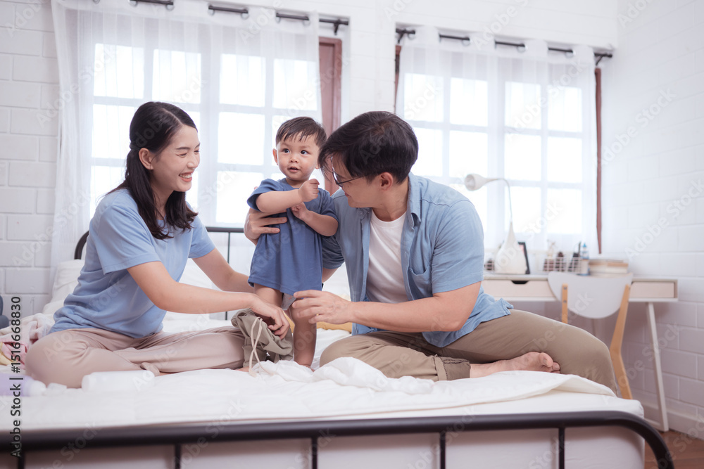 Fototapeta premium Asian kid and parents enjoying are having fun applying cream, powder and dressing up