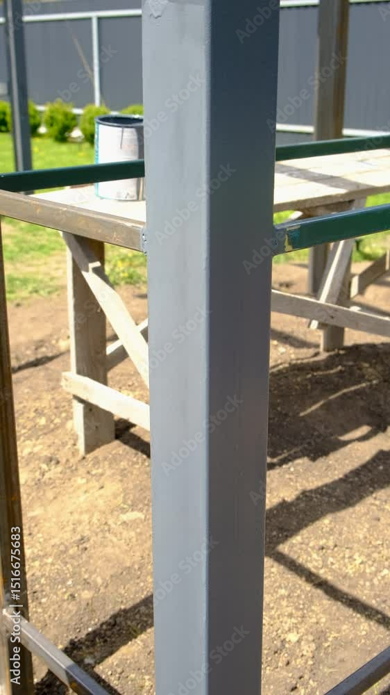 Man painting wooden poles. Selective focus. Man painting wooden poles. Selective focus.