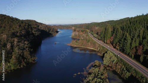 Aerial View of Forest Road Along Serene River in Southern Chile