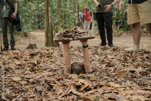 Cu Chi Tunnels. Tourists try to enter the underground tunnels. These tunnels were used in the Vietnam war. Famous tourist attractions in Vietnam