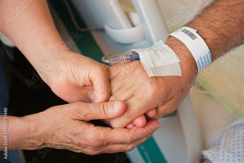 Nurse comforting elderly patient by holding his hand, providing support and empathy during hospital stay