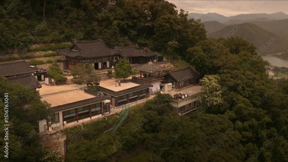 Traditional Korean temple surrounded by lush forest Traditional Korean temple surrounded by lush forest