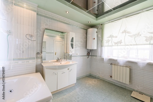 Wallpaper Mural well-lit bathroom with pastel colors, featuring a tub, vanity, mirror, and water heater. Tiled walls and floors create a clean aesthetic Torontodigital.ca