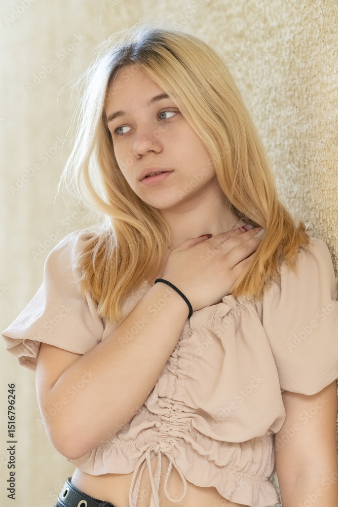 Naklejka premium Close-up portrait of young beautiful blonde girl outdoors.