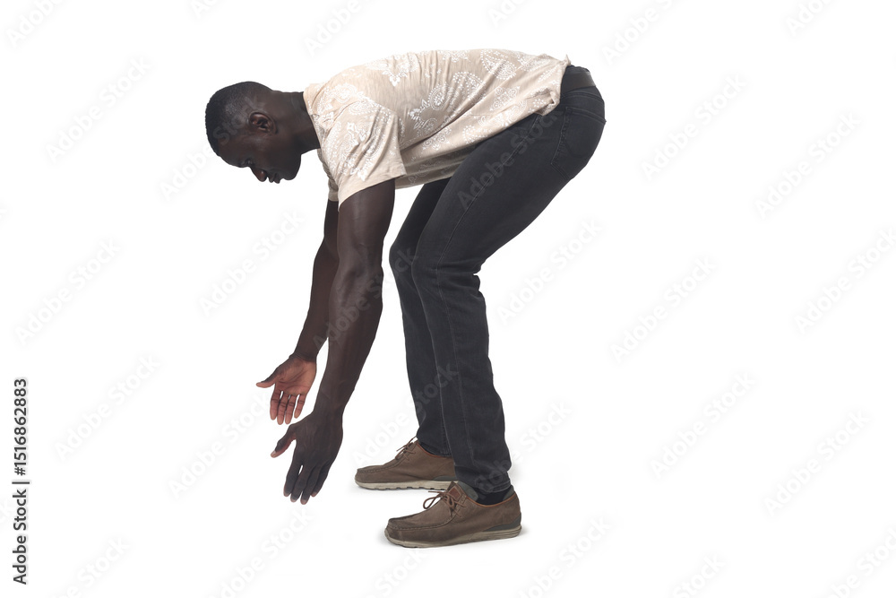 Naklejka premium side view of a man lifting something imaginary, large or heavy from the ground on white background