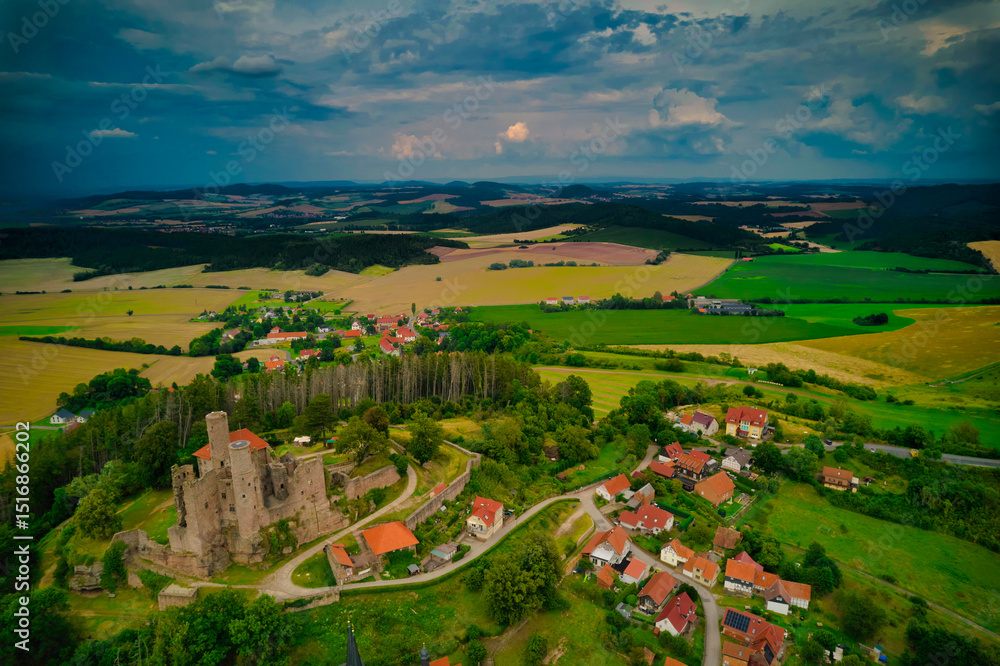 Naklejka premium Stunning Aerial View of a Magnificent Ancient Castle Enveloped by Verdant Lush Landscapes. Hanstein castle, Germany.