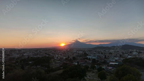 Sunset over the exploding Popocatpetl volcano, time lapse
