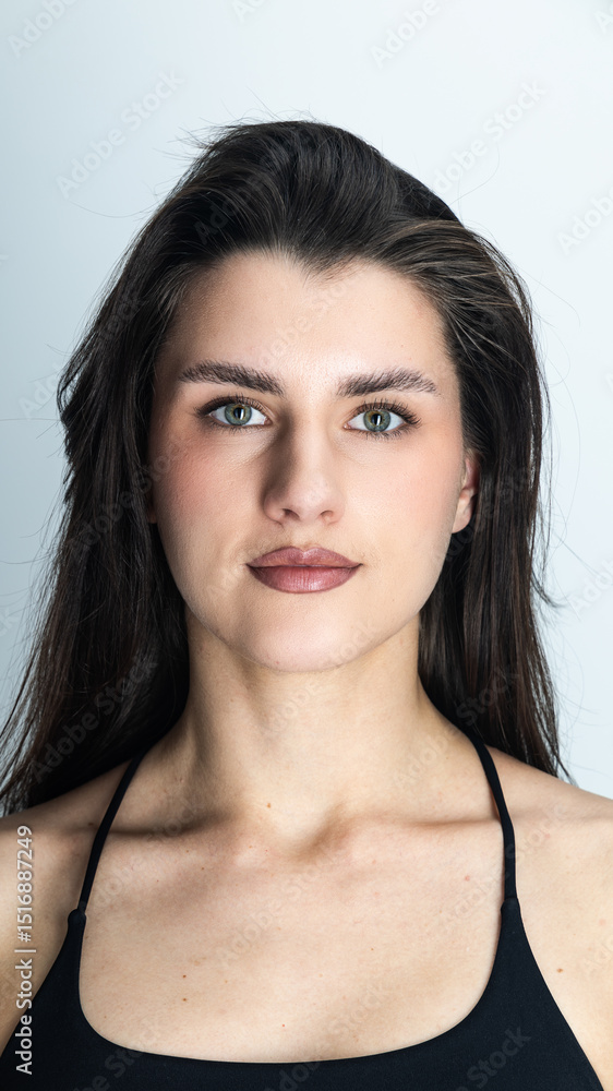 Obraz premium Portrait of confident young woman with long dark hair and brown eyes