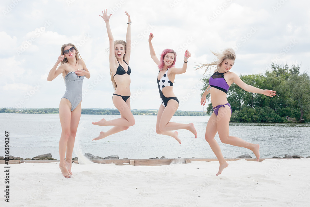 four attractive girls resting on the beach bar, drink a refreshing cocktail four attractive girls resting on the beach bar, drink a refreshing cocktail