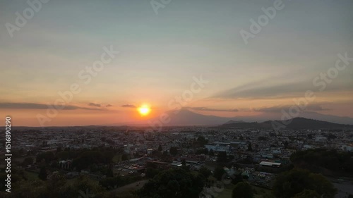 Sunset over the exploding Popocatpetl volcano, time lapse