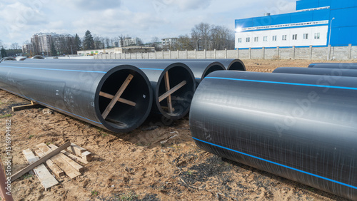 Tableau sur toile Construction site featuring various diameters of polyethylene pipes for water supply
