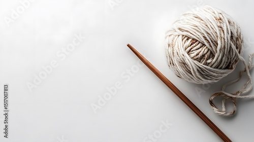 Close up of yarn ball and knitting needle on white background for crafting and hobby related projects