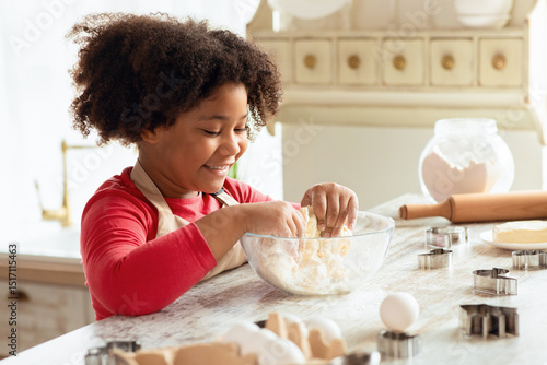 Adorable Little Black Girl Kneading Dough For Cookies, Having Fun In Kitchen Interior. Cute African American Child Enjoying Cooking And Making Homemade Pastry, Side View, Closeup Shot