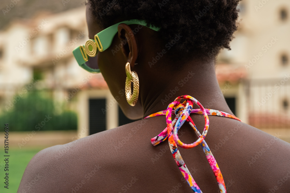© Milles Team/Stocksy - Woman wearing sunglasses and golden earrings outdoors