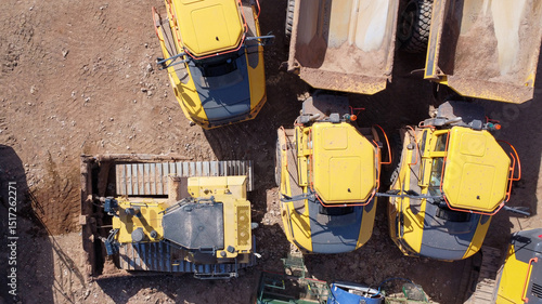  Aerial top down view of quarrying vehicles parked by a field