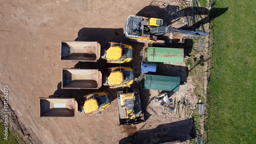  Aerial view of quarrying vehicles parked by a field