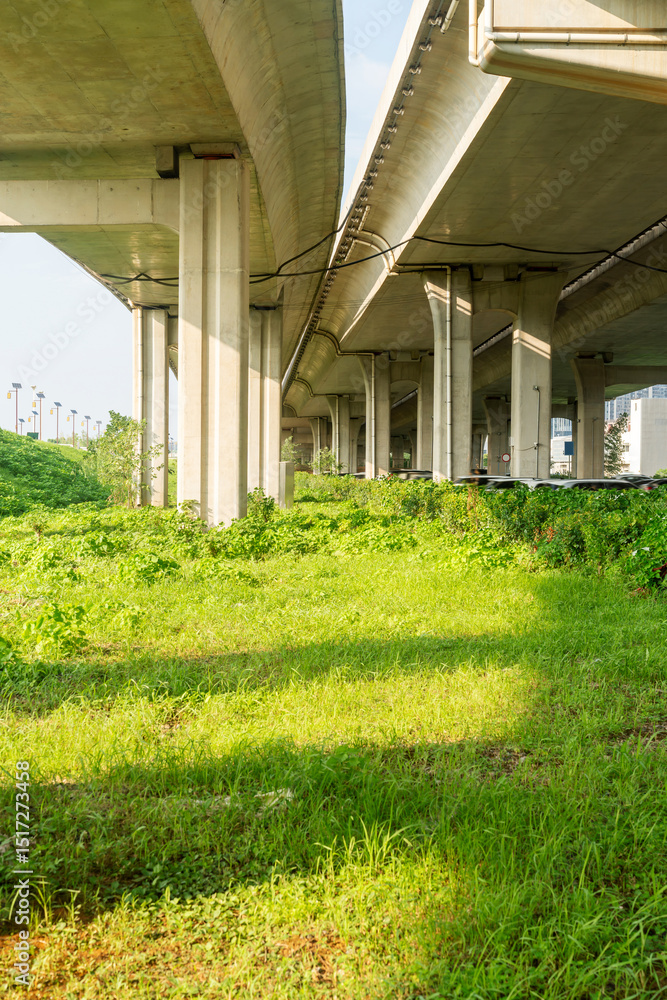 Obraz premium Concrete structure and asphalt road space under the overpass in the city