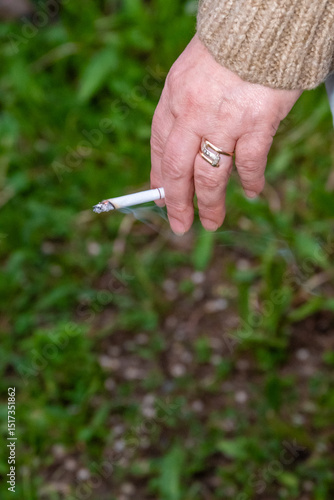Wallpaper Mural Hand holding a cigarette. Addiction concept. High quality photo Torontodigital.ca