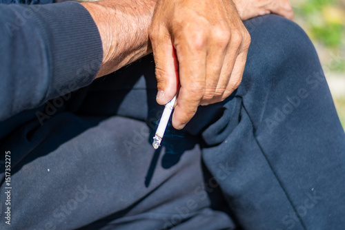 Wallpaper Mural Hand holding a cigarette. Addiction concept. High quality photo Torontodigital.ca