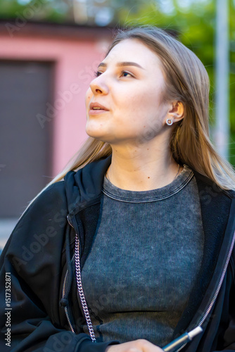 Wallpaper Mural Young woman smoking e-cigarette in the street. Addiction concept. High quality photo.	 Torontodigital.ca