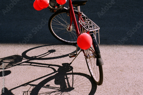 Bicycle decorated with red balloons